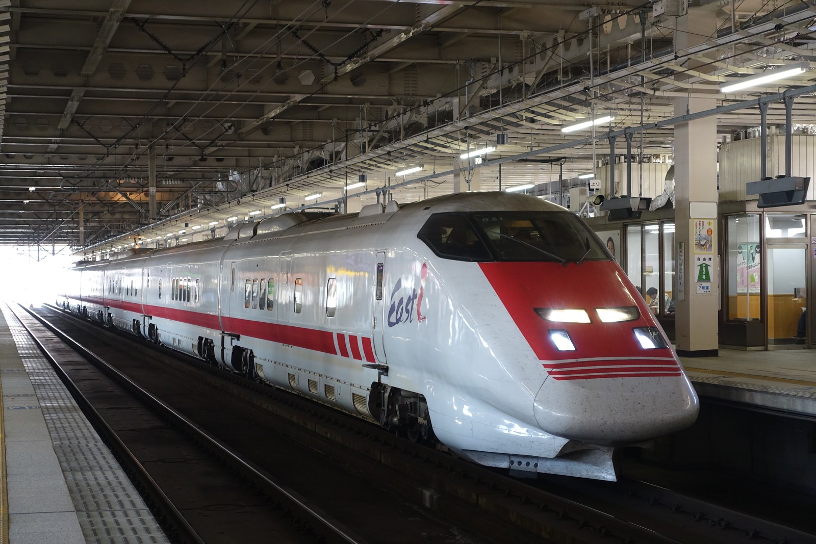 駅のホームに停車するEast i（E926形）。白い車体に赤い帯、先頭部に「East i」のロゴが入っている