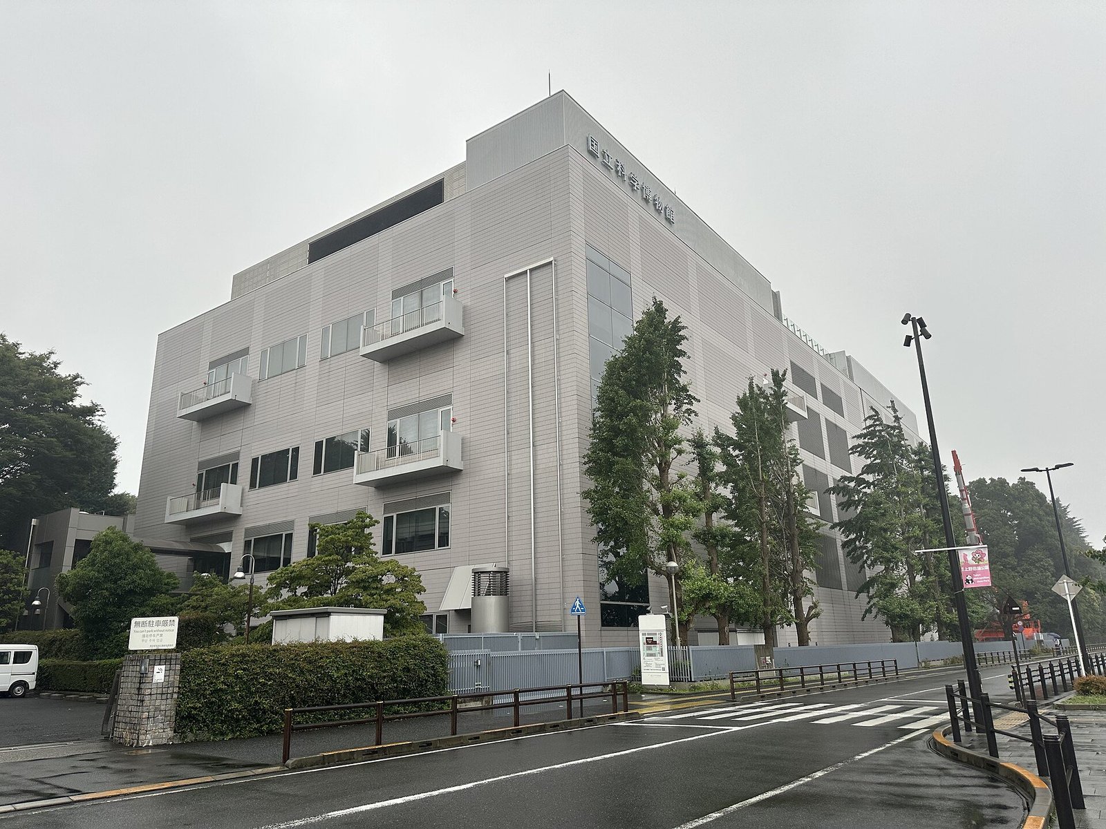 曇り空の下に立つ国立科学博物館 地球館の建物外観。灰色のパネル壁に「国立科学博物館」の文字